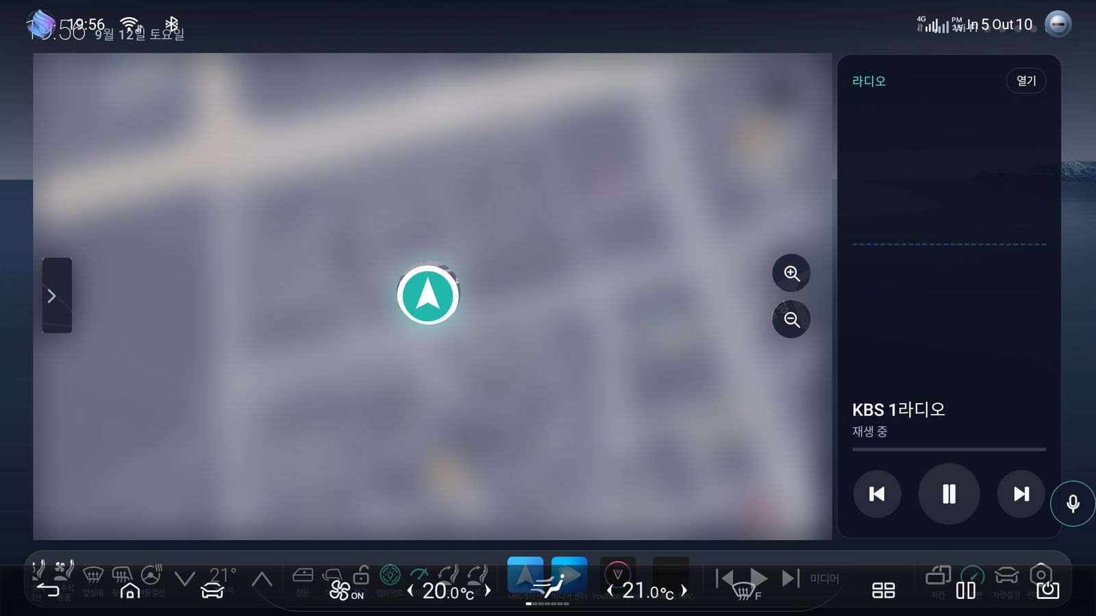 The map screen with the map itself blurred for privacy, and the radio panel alongside it.