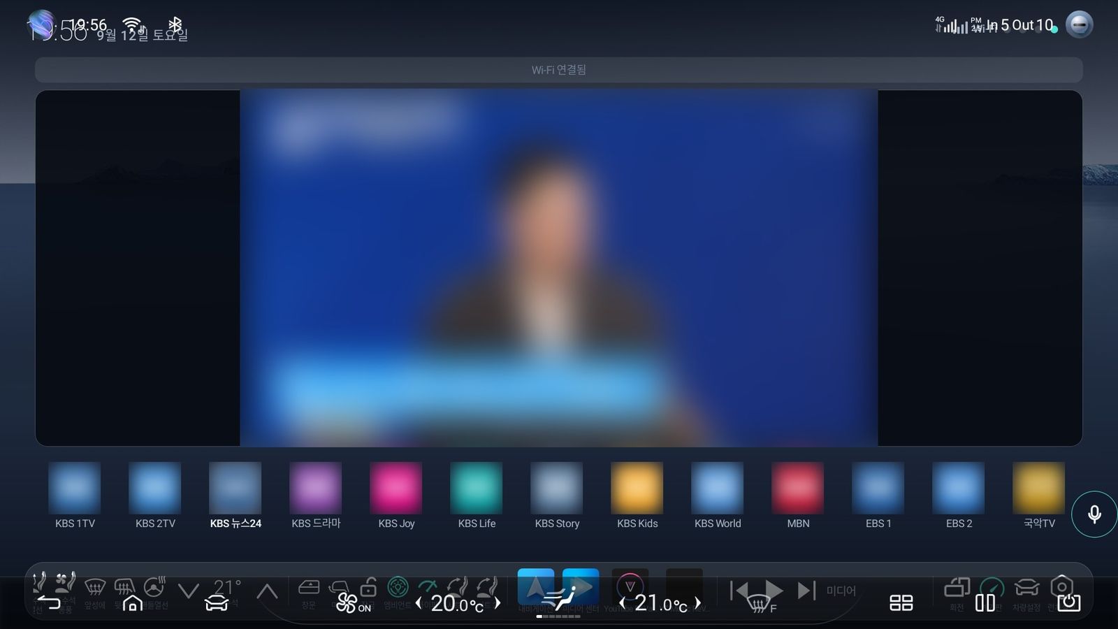 Live television filling the centre screen with the picture blurred, and channel tiles below.